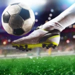 football scene at night match with close up soccer boot hitting ball with power